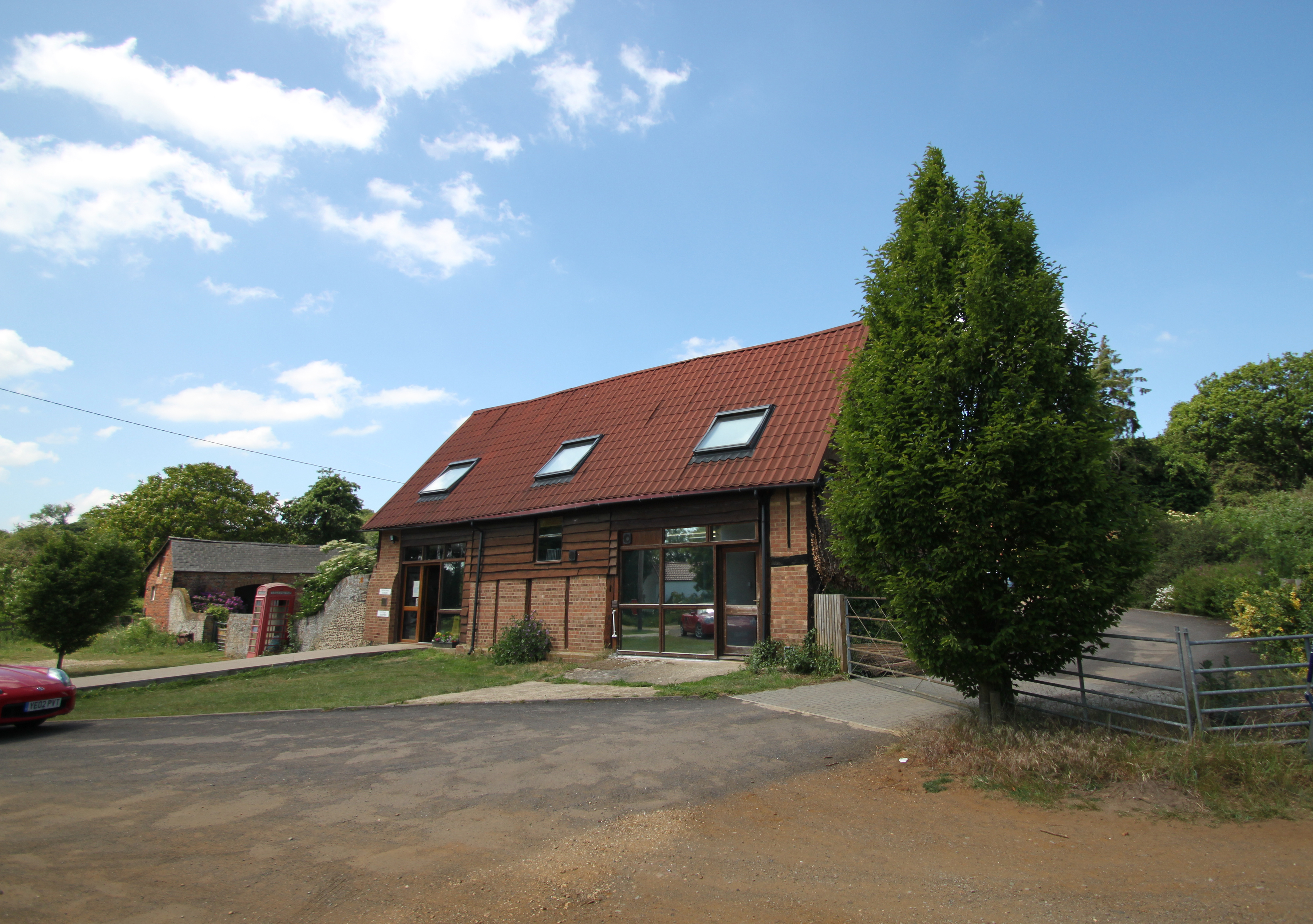 Heath & Reach Veterinary Surgery — a converted barn with red phone box and flint wall