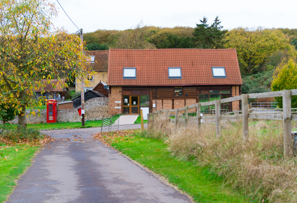 The practice viewed from the driveway, with the red phone box at the entrance
